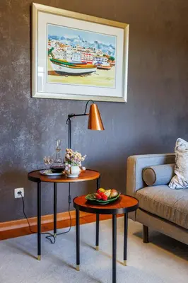 a living room with two tables and a couch at Villa Tranberg Suites in Ferreiras