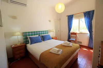 a bedroom with a bed with towels on it at Vilamoura Concept Villa With Pool by Homing in Vilamoura
