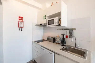 a small kitchen with a sink and a microwave at BeGuest Oceanic Rainbow Apt in Albufeira