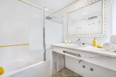 a white bathroom with a sink and a mirror at Vista Portuguesa by OCvillas in Albufeira