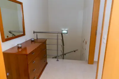 a bathroom with a wooden dresser and a mirror at Villa facing the pool by Algarve Dream Holidays in Fontainhas