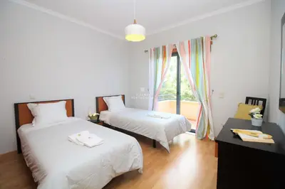 a bedroom with two beds and a window at Apartment Garcas Lounge - By Dalma Portuguesa in Albufeira