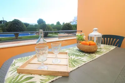 a table with two glasses and a bottle on a tray at Apartment Garcas Lounge - By Dalma Portuguesa in Albufeira