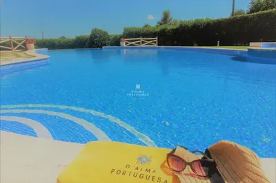 a pair of sunglasses sitting next to a swimming pool at Apartment Garcas Lounge - By Dalma Portuguesa in Albufeira