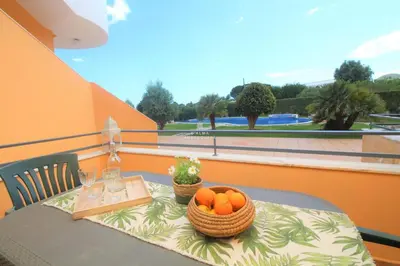 a table with a basket of oranges on a balcony at Apartment Garcas Lounge - By Dalma Portuguesa in Albufeira