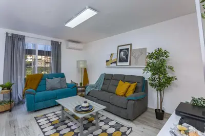 a living room with two couches and a table at Vilar do Jardim - Terrace and Pool - Vilamoura in Quarteira