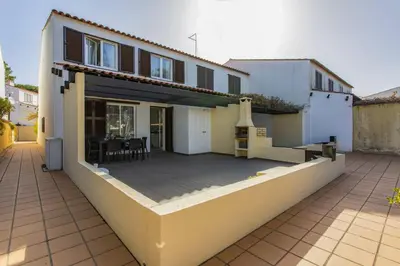 a house with a large patio in front of it at Vilar do Jardim - Terrace and Pool - Vilamoura in Quarteira