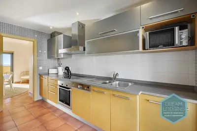 a kitchen with a sink and a microwave at Oceanus Jardim - Dream Lodging in Albufeira