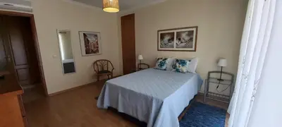 a bedroom with a bed and two chairs in it at Albufeira Apartment Pool & Tennis in Albufeira
