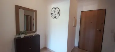 a room with a clock on the wall next to a door at Albufeira Apartment Pool & Tennis in Albufeira