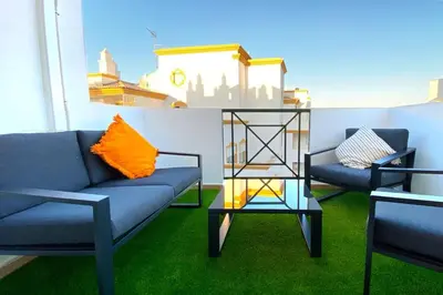 a living room with two couches and a table at Albufeira Central Apartment, 10 mins walk to beach in Albufeira