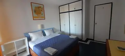 a small bedroom with a blue bed and a closet at CASA ROMAN Poente da Aldeia in Albufeira