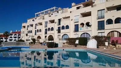 a hotel with a swimming pool in front of a building at CASA ROMAN Poente da Aldeia in Albufeira