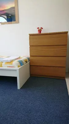 a bedroom with a bed with a wooden dresser at CASA ROMAN Poente da Aldeia in Albufeira