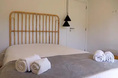 a bedroom with a bed with rolled towels on it at Villa Hibiscus, great location in Vilamoura, lush green lawns and garden in Quarteira