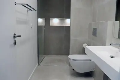 a bathroom with a shower and a toilet and a sink at Villa Hibiscus, great location in Vilamoura, lush green lawns and garden in Quarteira