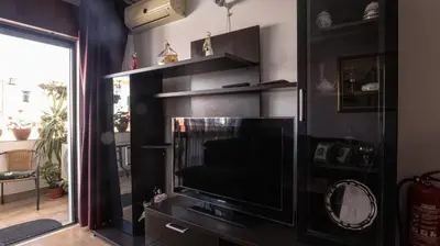 a living room with a television and a fireplace at Apartamento Pateo - Algarve - BY BEDZY in Albufeira