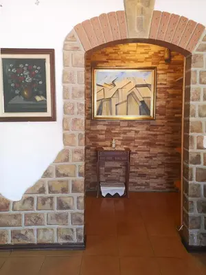 a brick walled room with a table and a painting at Apartamento Pateo - Algarve - BY BEDZY in Albufeira