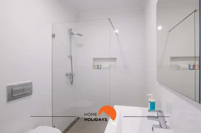 a white bathroom with a shower and a sink at #096 Casa Antonieta 1 by Home Holidays in Albufeira