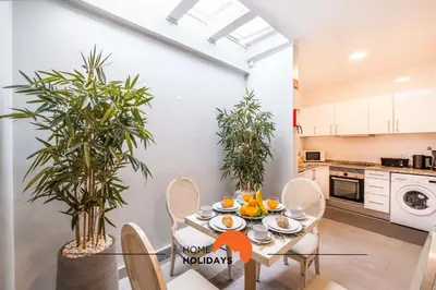 a kitchen and dining room with a table and chairs and plants at #096 Casa Antonieta 1 by Home Holidays in Albufeira