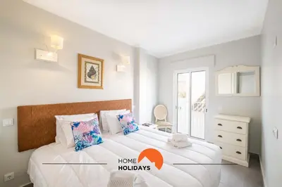 a bedroom with a large white bed and a window at #097 Casa Antonieta 2 by Home Holidays in Albufeira