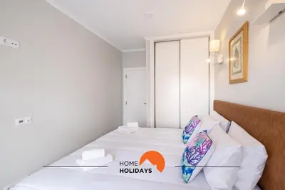 a bedroom with a bed with the words home huddles at #097 Casa Antonieta 2 by Home Holidays in Albufeira