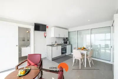 a kitchen and dining room with a view of the ocean at #098 Casa Antonieta 3 by Home Holidays in Albufeira