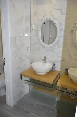 a bathroom with two sinks and a mirror at Marina Plaza, Vilamoura in Vilamoura