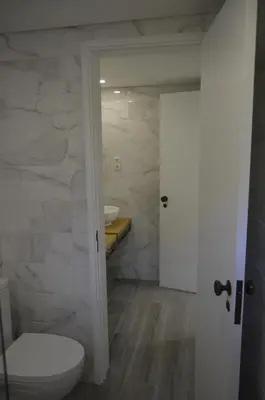 a bathroom with a toilet and a sink at Marina Plaza, Vilamoura in Vilamoura