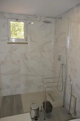 a bathroom with a shower with a glass door at Marina Plaza, Vilamoura in Vilamoura