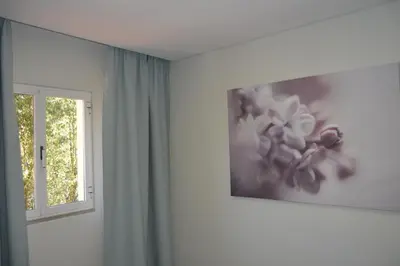 a room with a window and a picture on the wall at Marina Plaza, Vilamoura in Vilamoura