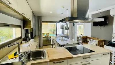 a kitchen with a sink and a dining room at Praia by Check-in Portugal in Albufeira