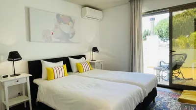 a bedroom with two beds and a window at Praia by Check-in Portugal in Albufeira