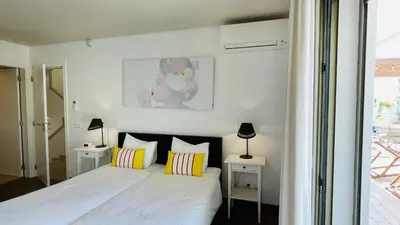 a bedroom with a bed with two night stands and two lamps at Praia by Check-in Portugal in Albufeira