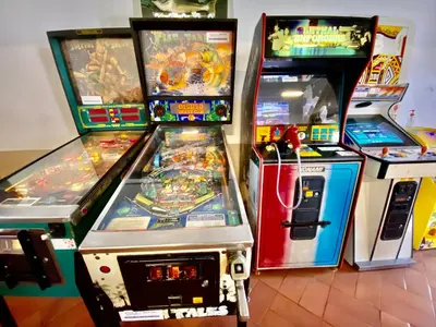 a group of arcade games sitting next to each other at Fresh and cosy appt with Pool, Fiber, LargeTV, Gaming Room in Albufeira