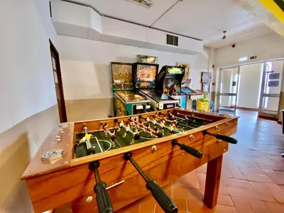 a room with a foosball table and arcade games at Fresh and cosy appt with Pool, Fiber, LargeTV, Gaming Room in Albufeira