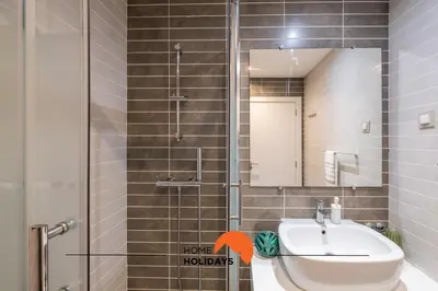 a bathroom with a sink and a shower with a mirror at #092 Quinta dos Figos by Home Holidays in Albufeira