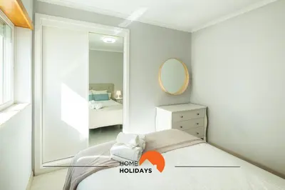 a bedroom with a mirror and a bed at #086 Fish House by Home Holidays in Albufeira