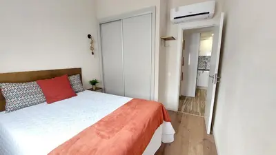 a bedroom with a bed with a red pillow at Airport house in Faro