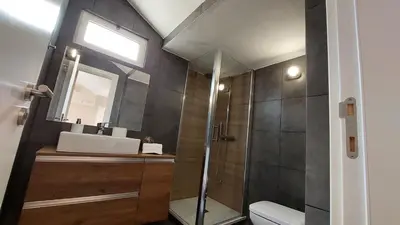 a bathroom with a shower and a sink and a toilet at Airport house in Faro