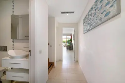 a hallway leading to a bathroom with a sink at Albufeira Townhouse beach in Albufeira