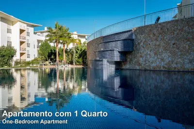 a body of water in front of a building at Akisol Albufeira Rainbow in Albufeira
