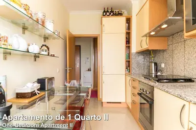 a kitchen with a glass counter top in a room at Akisol Albufeira Rainbow in Albufeira