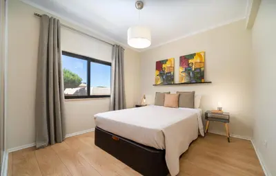 a bedroom with a large bed and a window at AL - Apartamento Sol Nascente 1 Top Floor in Quarteira