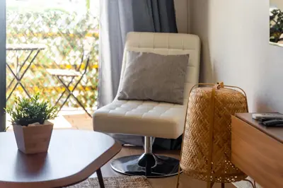a living room with a chair and a table at AL - Apartamento Sol Nascente 1 Top Floor in Quarteira