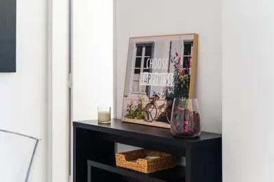 a room with a black console table with a mirror at AL - Apartamento Sol Nascente 1 Top Floor in Quarteira