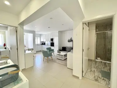 an open kitchen and living room in a apartment at Nutmeg - 50mtrs to beach - by HD PROPERTIES in Quarteira