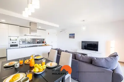 a living room with a couch and a table with fruit on it at #090 Correeira by Home Holidays in Albufeira