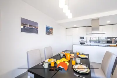 a dining room with a black table and chairs at #090 Correeira by Home Holidays in Albufeira