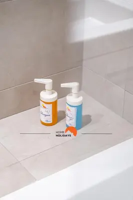 two bottles of medicine sitting on a bathroom counter at #090 Correeira by Home Holidays in Albufeira